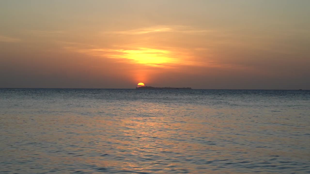 Sunset - Sun setting behind an island