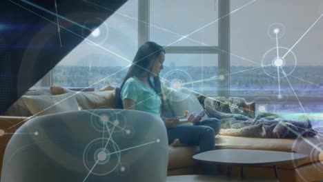 Animation-of-network-of-connections-over-asian-woman-having-a-snack-and-using-smartphone-at-home