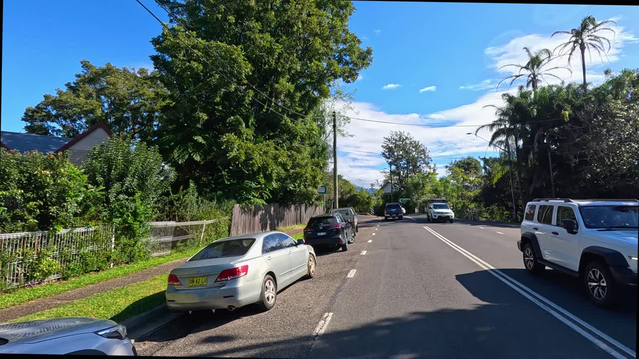 A 20-second drive through Bellingen, showcasing lush greenery, clear skies, and light traffic on a sunny day