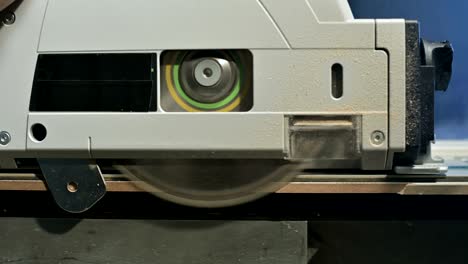 close-up circular saw on the edge of the chipboard plate