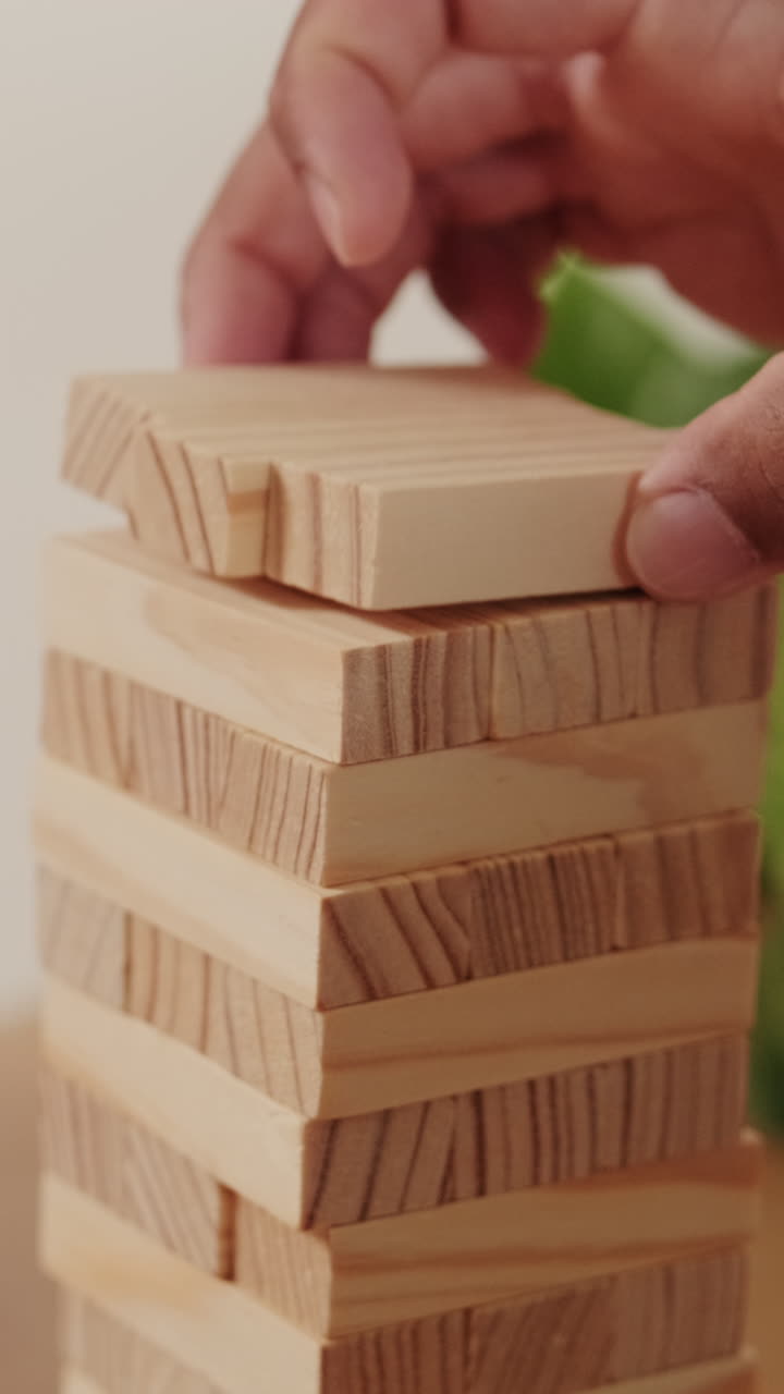 Couple Playing Block Stacking Game At Home