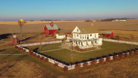 a drone aerial establishing shot over a classic beautiful farmhouse farm and barns in rural midwest america york nebraska 8