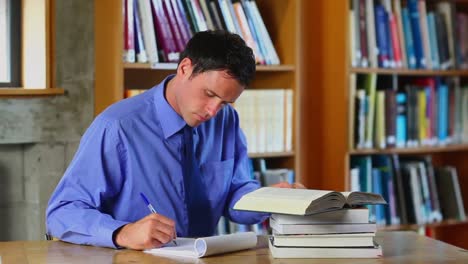 serious lecturer preparing a class in the library