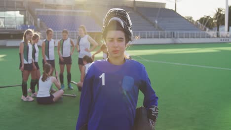 female hockey players smiling and looking at camera