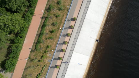 Aerial Top-Down View of a Riverside Promenade with Walkways and Greenery