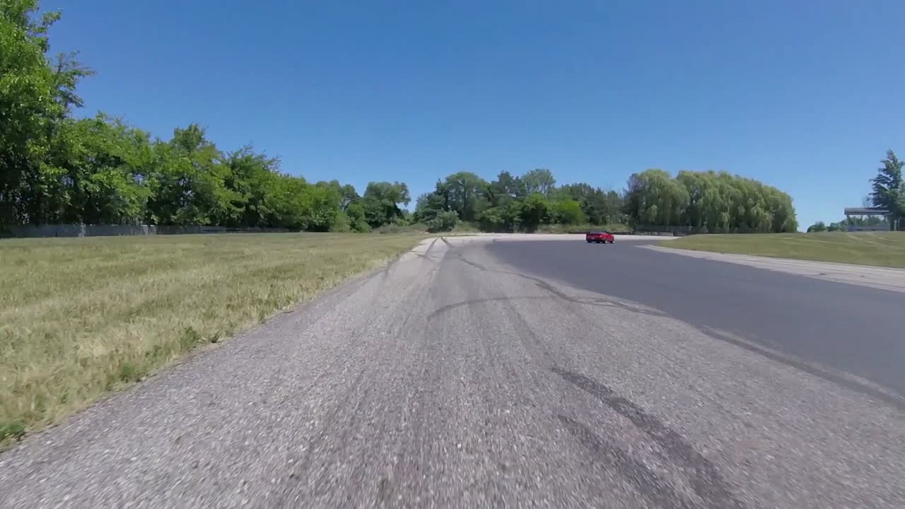 Red Car Driving on a Race Track