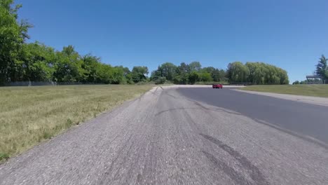 red car driving on a race track