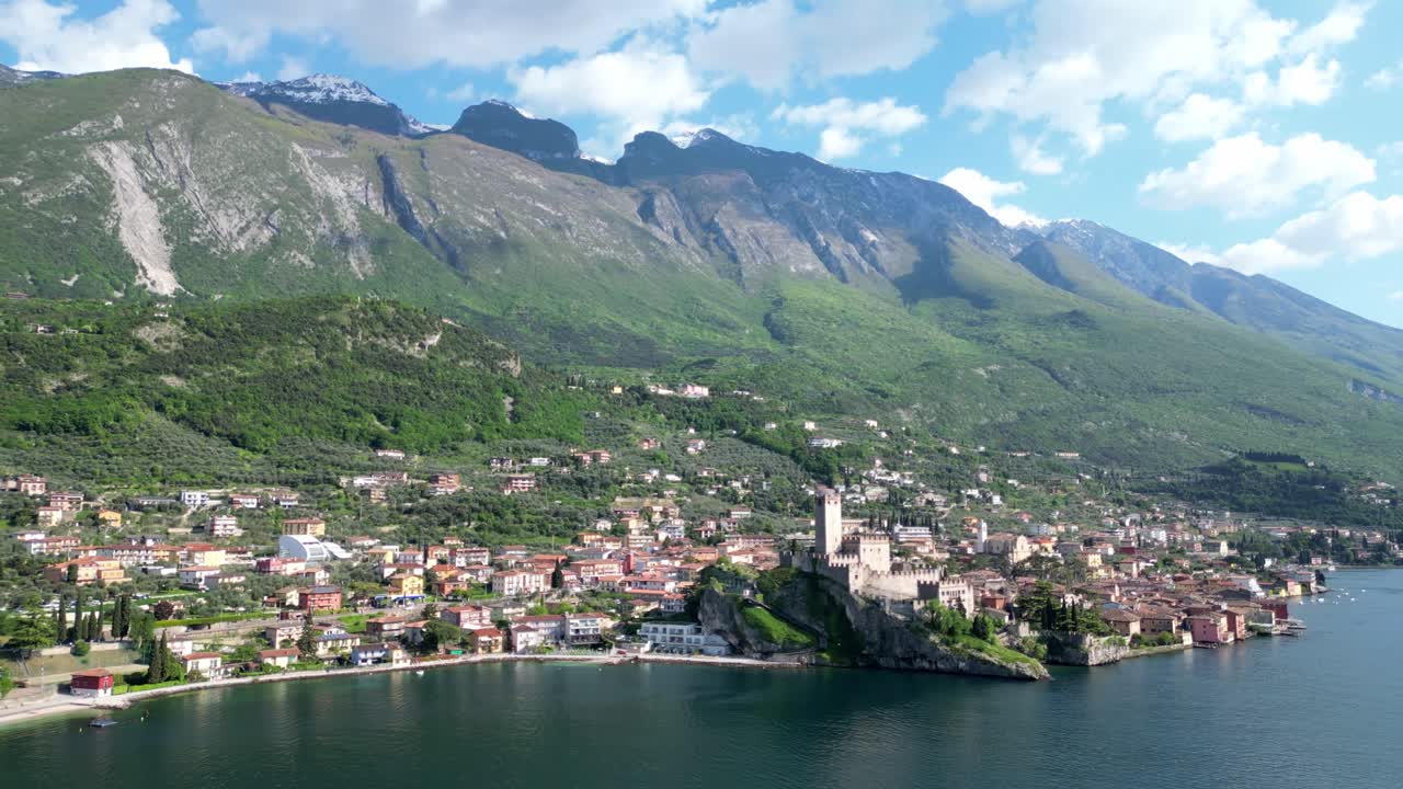 Wide aerial view of Malcesine with Castello Scaligero on Lake Garda’s shoreline. Malcesine, Italy