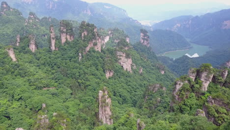 aerial flies over tourism viewpoint to dramatic valley of rock spires