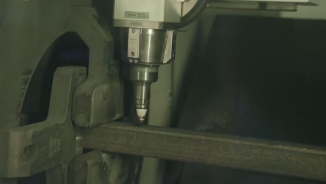 fast footage of a laser cutting machine cutting through a steel frame pipe