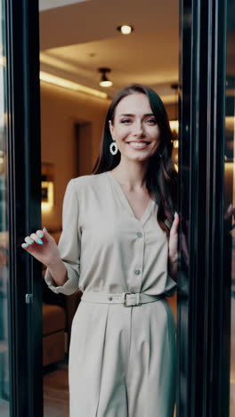 woman in a beige jumpsuit at the doorway