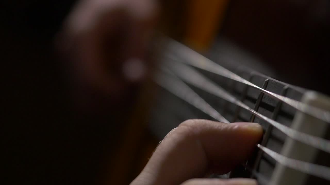 Close-up of hands playing guitar