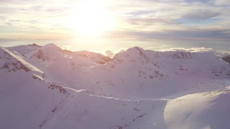 snowy mountain peaks at sunrise/sunset