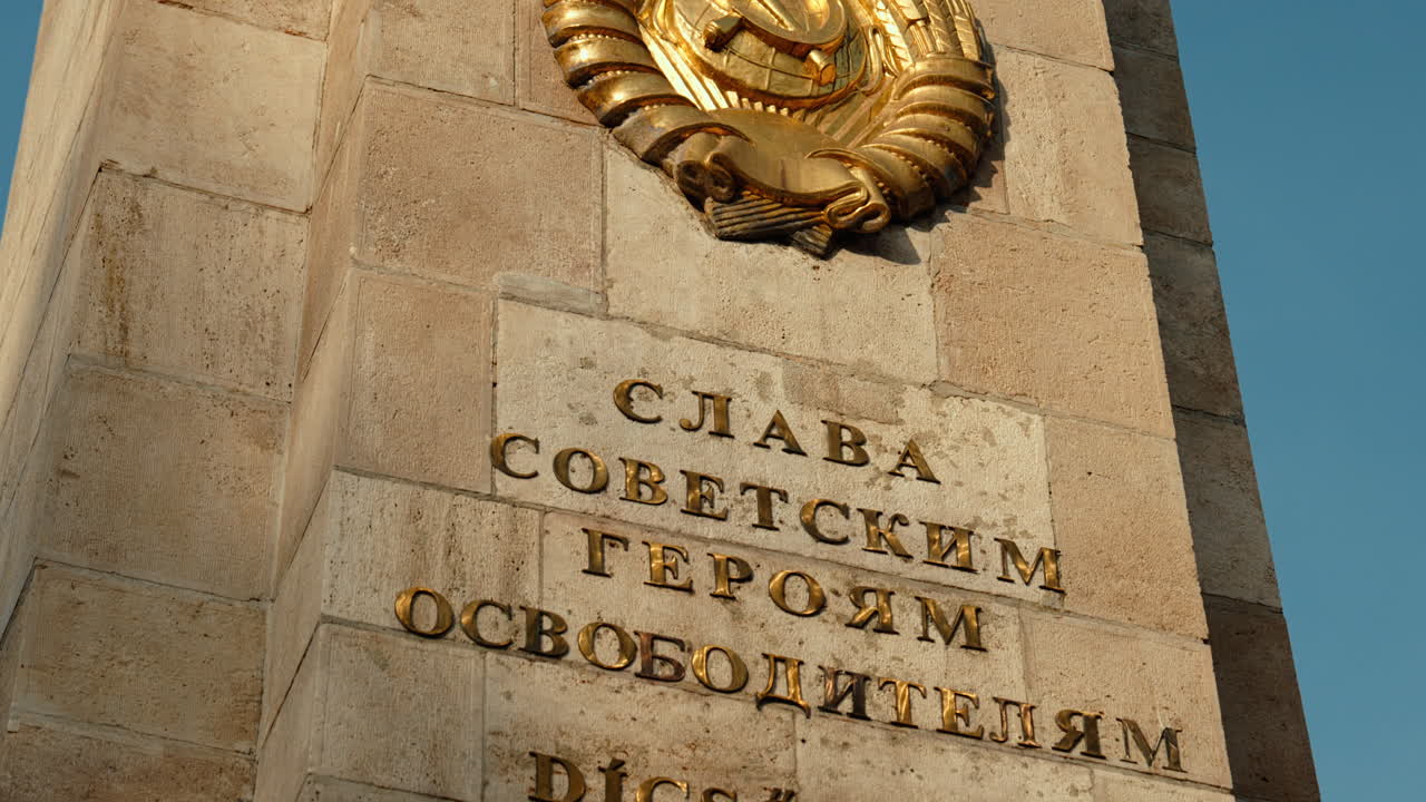 Detailed close-up of the hammer-and-sickle emblem on a Soviet war memorial in Budapest, symbolizing Red Army history, USSR presence, and Cold War heritage
