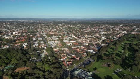 aerial flight over australian neighborhood during sunny day with blue sky in perth suburb