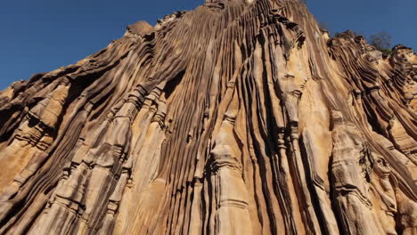 unique textured rock formation against blue sky