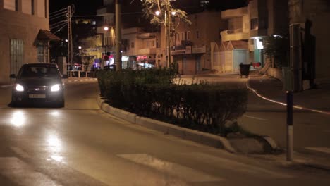car driving on a city street at night
