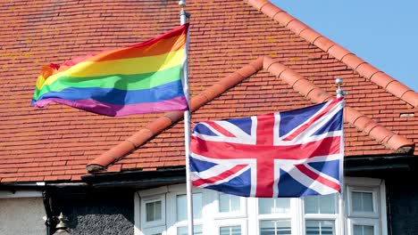 rainbow and union jack flags waving together