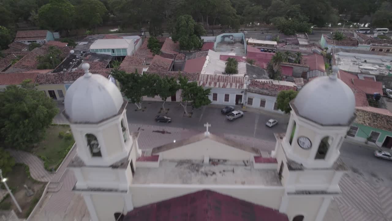 Aerial view of Cumana cityscape and cathedral under cloudy sky