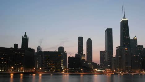 lights brighten as the sky darkens in downtown chicago