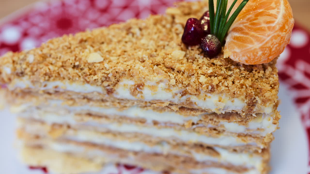 Close up of a slice of Medovik cake on a red and white plate