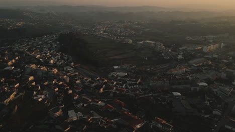 Golden-Dusk-over-Felgueiras-city,-Portugal-cityscape---Aerial-flyover