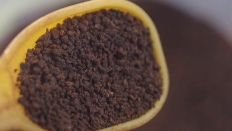 loose leaf tea in a yellow spoon