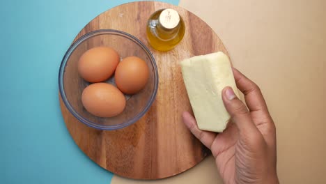 preparing food with eggs, butter, and olive oil