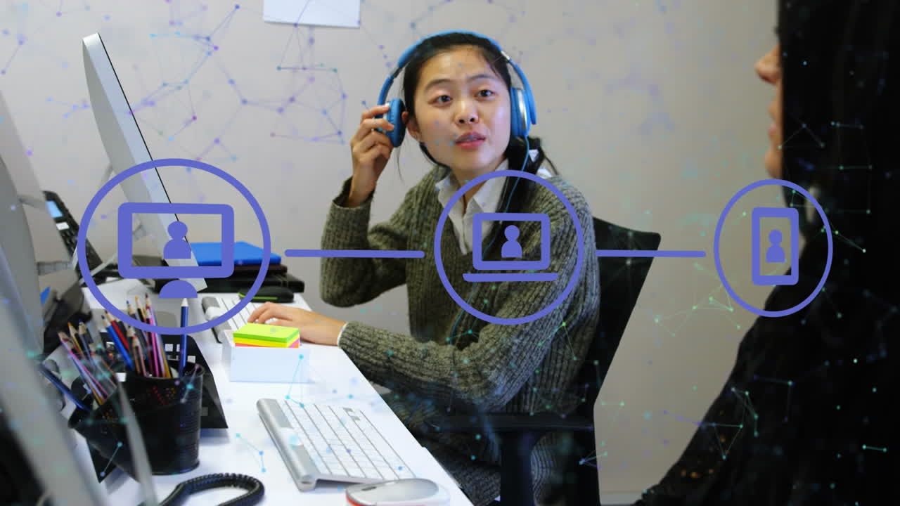 Animation of network of connections and icons over asian businesswoman in office
