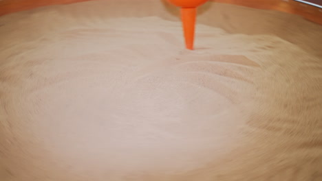 the pendulum draws on the sand. science exhibition museum.