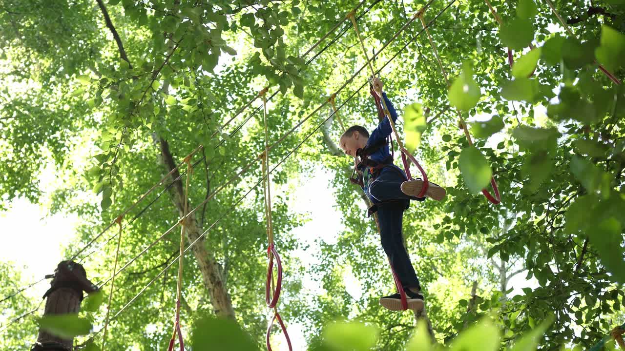 Child enjoying a treetop adventure course