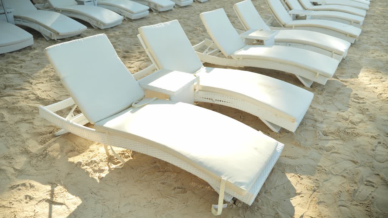 Quiet tropical morning with arranged beach chairs ready for relaxing guests