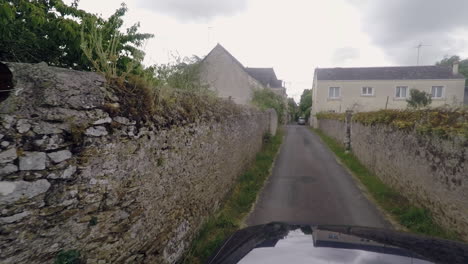 pickup truck hood view driving through narrow street in france