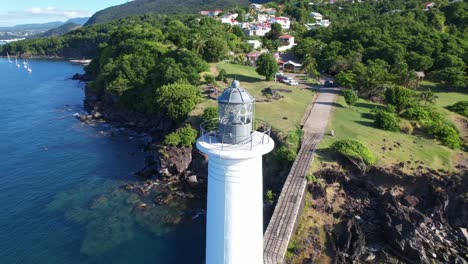 old lighthouse at vieux fort in guadeloupe, aerial orbit view