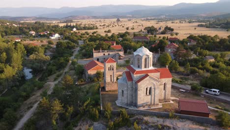 Monastery-hermitage-above-croatia-eye-of-the-earth,-aerial-rising-tilt-down