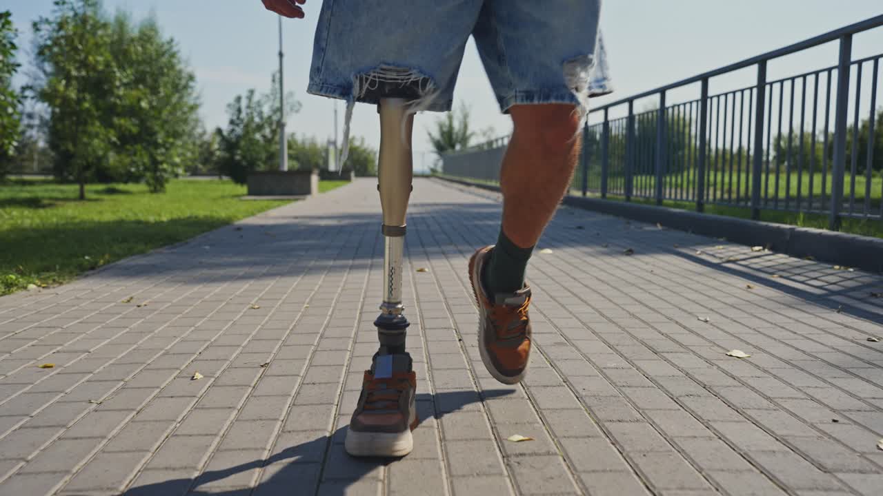 Person with Prosthetic Leg Walking in Park