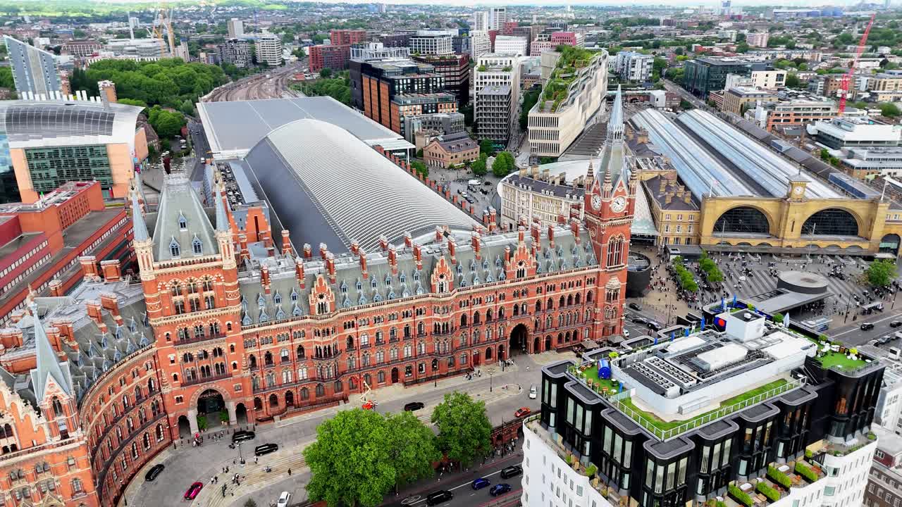 Aerial view of St Pancras International and King's Cross train stations, bustling London hub blending historic architecture with modern energy.