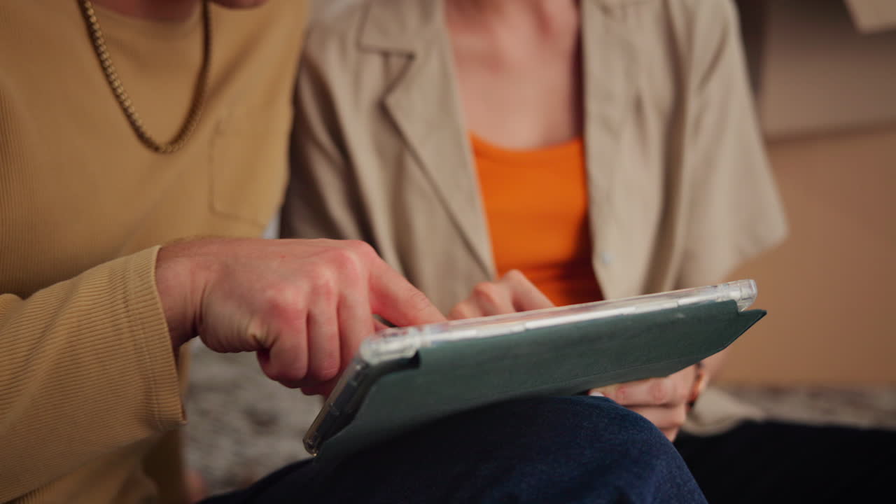 Close-up of Man and Woman Using Digital Tablet Together