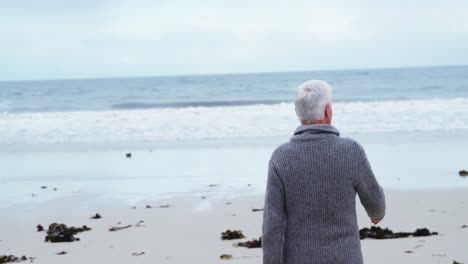 senior man walking on the beach