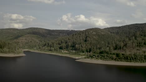 Scenic-Drone-Shot-of-a-beautiful-lake-at-sunset-in-the-Harz-National-Park,-Germany,-Europe