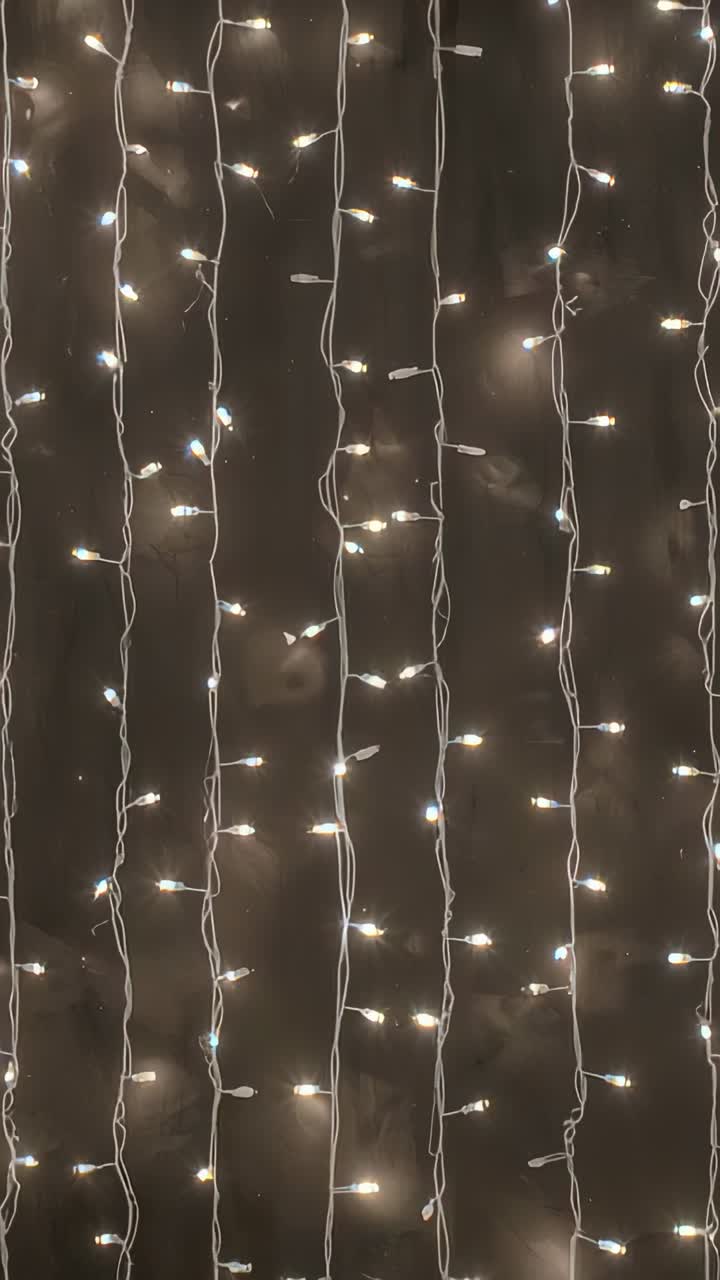 Vertical video: Recording string light curtain shifting, bulbs pulsing inside room with connectors
