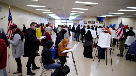 voters at a polling place, including women in hijabs