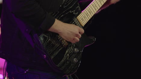 Musician-plays-beautiful-electric-guitar-on-stage-during-performance