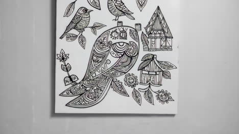ornate black and white line art drawing of a bird and birdhouse