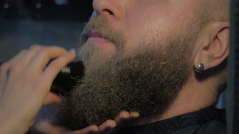 brushing beard in barbershop