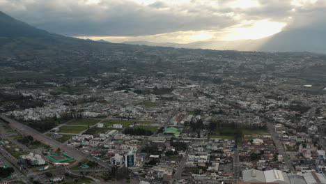 aerial view of a city at sunset with mountains
