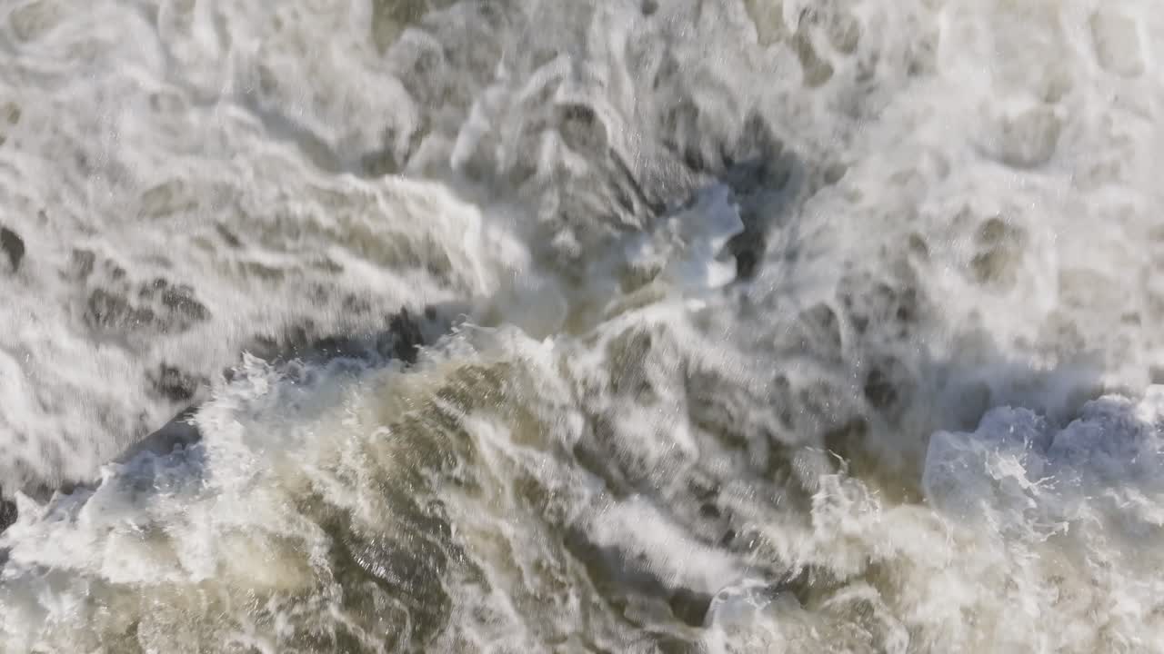 A powerful waterfall in owen sound, canada with rushing white water and mist, aerial view