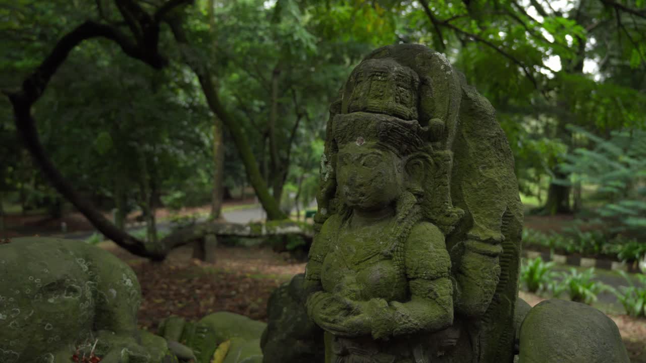 Old Shiva Stone Statue Covered In Moss At Bogor Botanical Gardens In Bogor, Indonesia. closeup shot