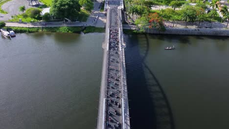 top-down tilting shot of a congested truong tien bridge revealing downtown hue