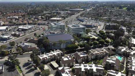 aerial, tracking, drone shot around a buildings rooftop, covered with solar panels, on a sunny day, at long beach, in los angeles, california, usa